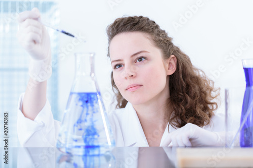 Woman chemist making a mixture