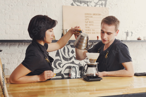 Canvas Print Male and female bartenders brewing fresh coffee