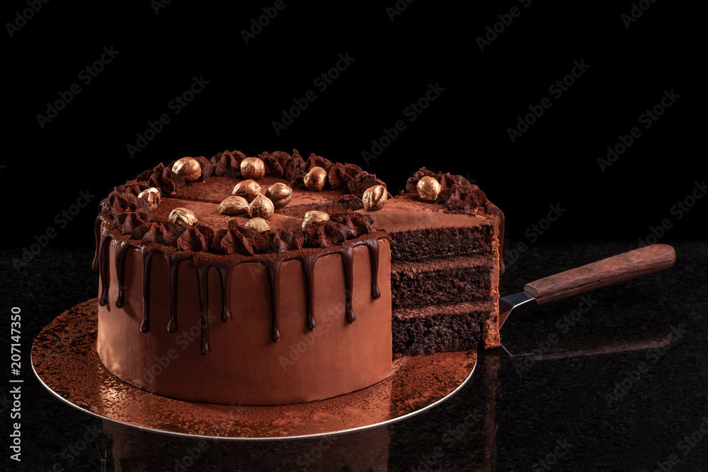 Chocolate cake with nuts on a black background Stock Photo | Adobe Stock
