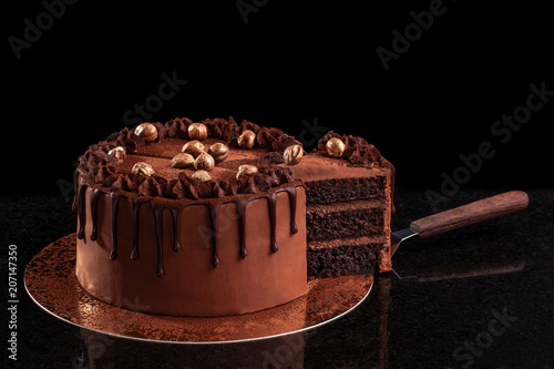 Chocolate cake with nuts on a black background