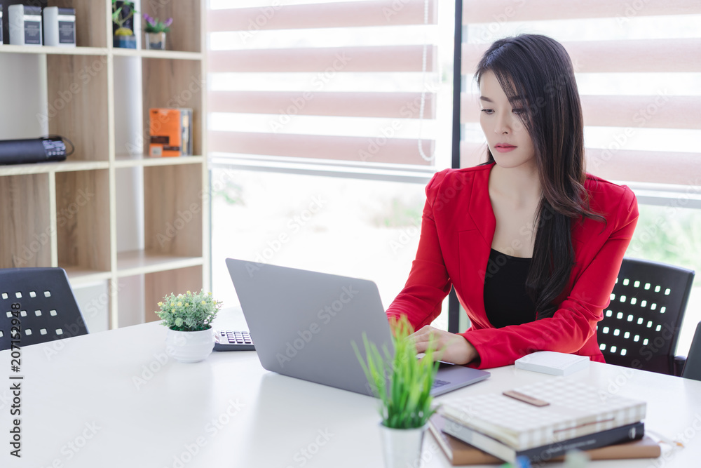 Beautiful attractive young asian business woman working with laptop at meeting or negotiation in the office. Beautiful attractive young asian business woman working with laptop at meeting or negotiation in the office.