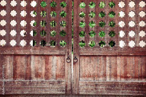 Fotografie wooden door gate with a forged handle ring