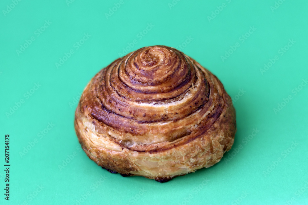 custom made wallpaper toronto digitalBun with cinnamon close-up on a light green background and copy space