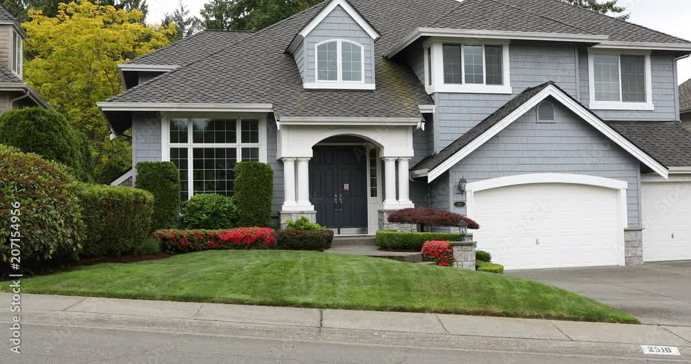Front view of entire home and yard during late spring season