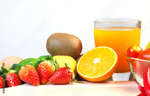 Healthy concept with mixed fruits and vegetables on wooden background