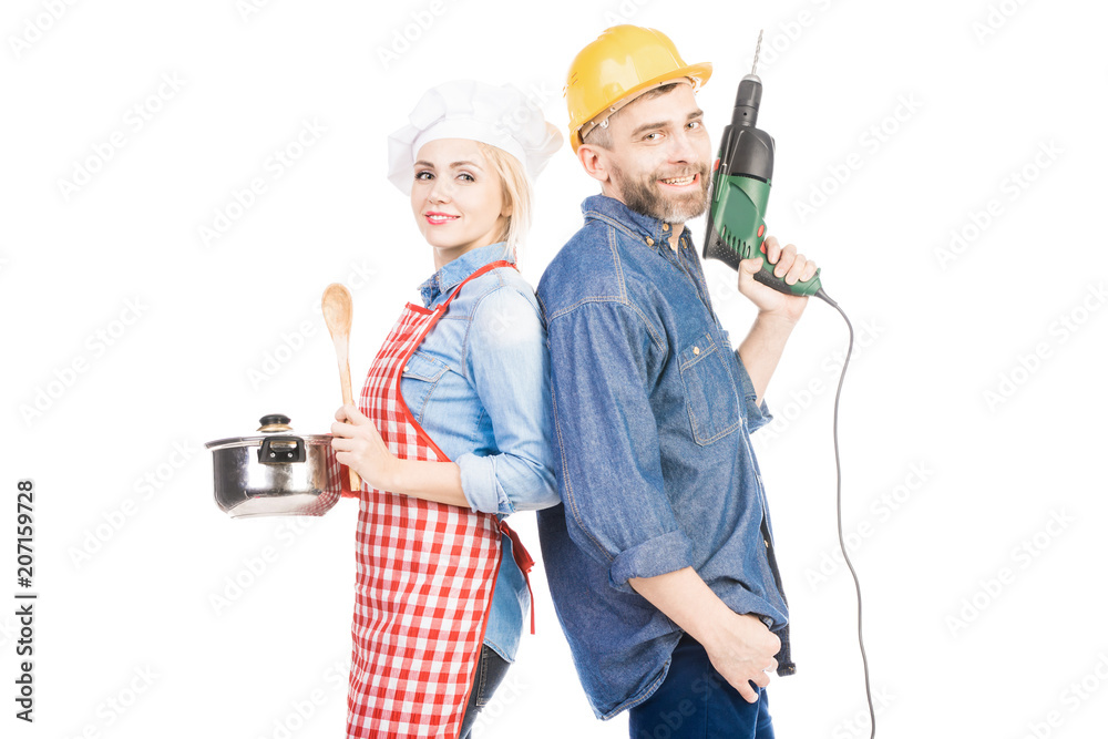 Attractive female cook with saucepan and bearded man with hand drill smiling at camera on white background Attractive female cook with saucepan and bearded man with hand drill smiling at camera on white background