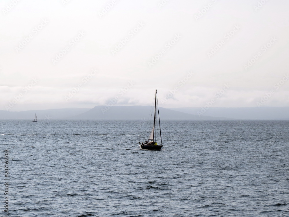 A yacht sailing under sail