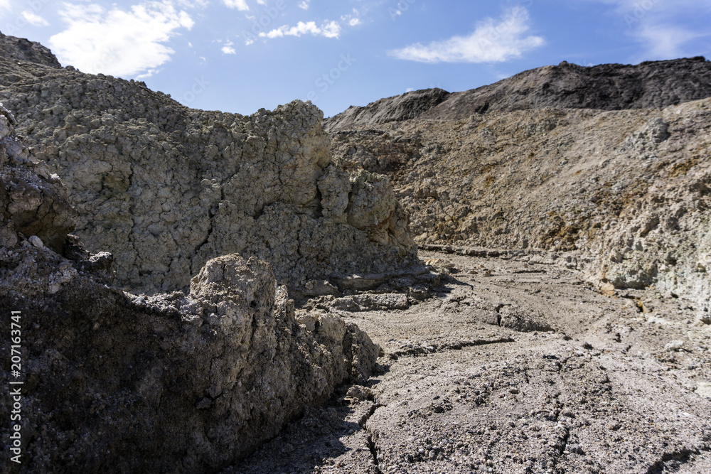 landscape - view from a dry desert canyon with a sandy-clay bottom and weathered slopes.. landscape - view from a dry desert canyon with a sandy-clay bottom and weathered slopes..