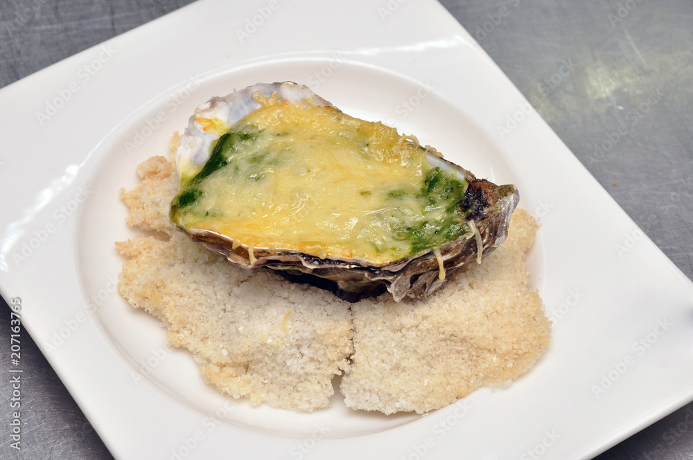 Oysters with sauce Sabayon. Oysters baked on a pillow of salt, with cheese. Oysters with sauce Sabayon. Oysters baked on a pillow of salt, with cheese.