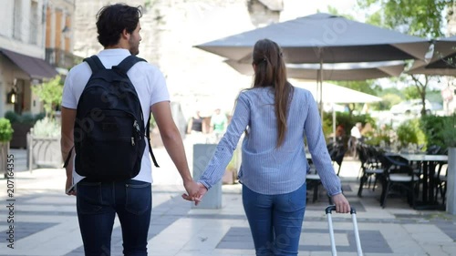 cheerful young couple on cultural weekend city trip discovering together historical european city in summer