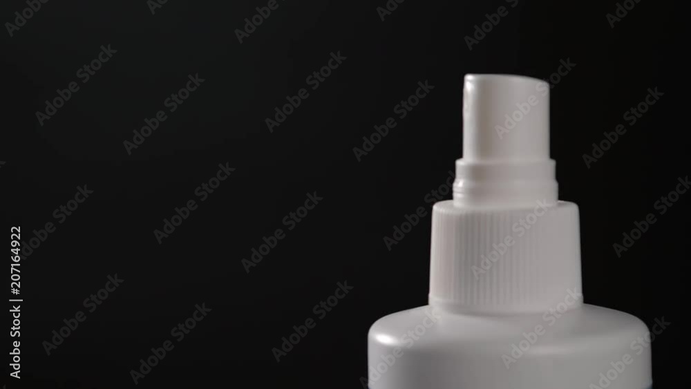 Close-up view of human hand and spray bottle isolated on black parfume moscito spray insects