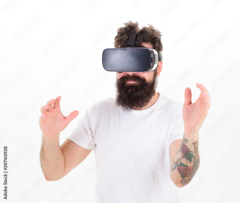 Man with beard in VR glasses making hand gestures on white background. Bearded man having 3D experience. Hipster with trendy beard watching 360 video on his new headset, modern devices concept Man with beard in VR glasses making hand gestures on white background. Bearded man having 3D experience. Hipster with trendy beard watching 360 video on his new headset, modern devices concept