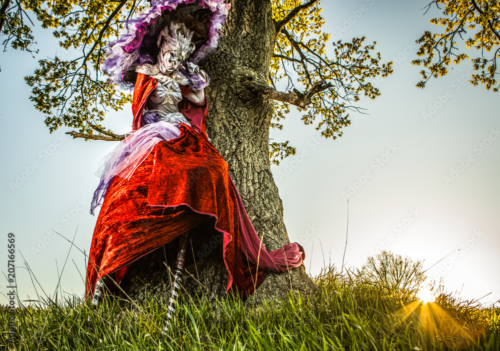 Fairy tale woman on stilts in bright fantasy stylization. Fine art outdoor photo. Fairy tale woman on stilts in bright fantasy stylization. Fine art outdoor photo.