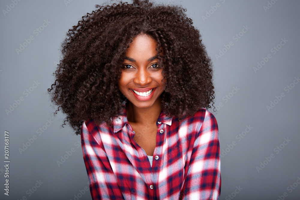 Close up stylish young african woman against gray background Close up stylish young african woman against gray background