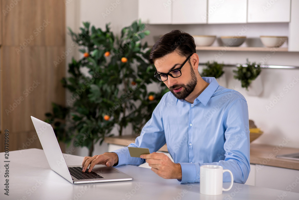 Handsome businessman using online payment service Handsome businessman using online payment service