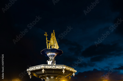Monument to Pachacutec (Inca ruler) over a fountain in the main square of Cusco (Peru) during the night