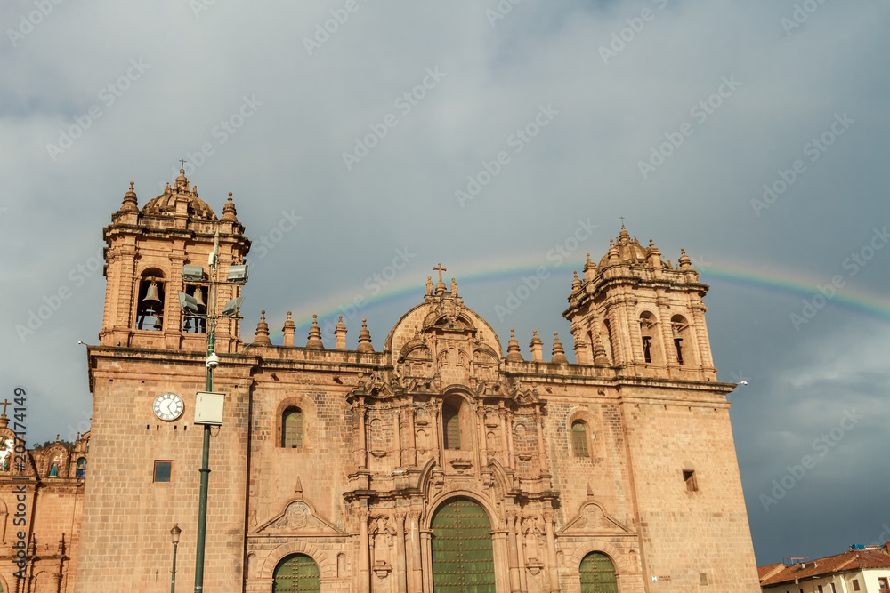 Rainbow is formed over the cathedral of Cusco (Peru)