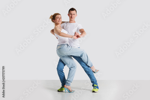 beauty couple dancing  on grey background.