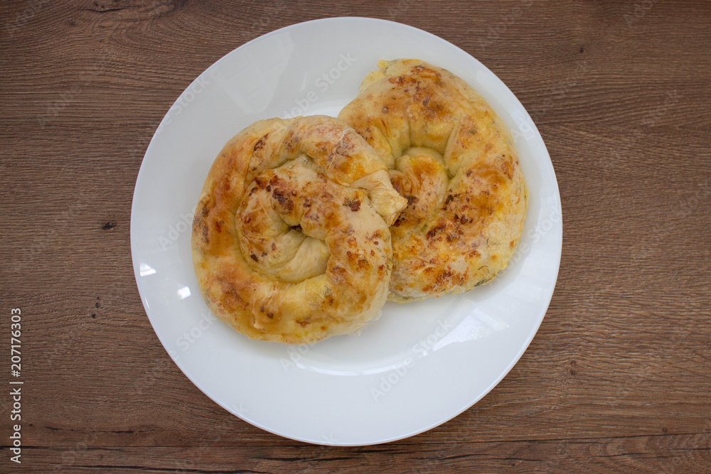Baked snack with stuffing with golden crust. Traditional moldavian food called platzinda Baked snack with stuffing with golden crust. Traditional moldavian food called platzinda