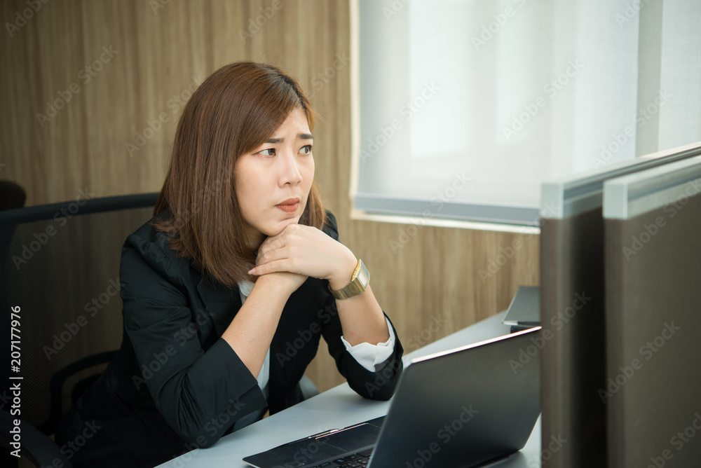 Asian woman working in office,young business woman stressed from work overload with a lot file on the desk,Thailand people,Worker think concept Asian woman working in office,young business woman stressed from work overload with a lot file on the desk,Thailand people,Worker think concept