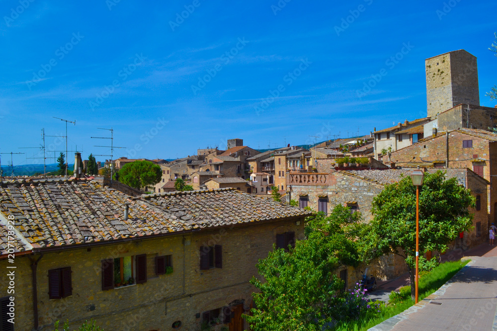 View of the town of San Gimignano with medieval houses and tower in Tuscany region, Italy