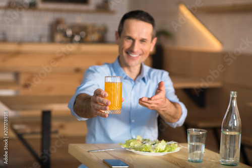 businessman holding glass of orange juice
