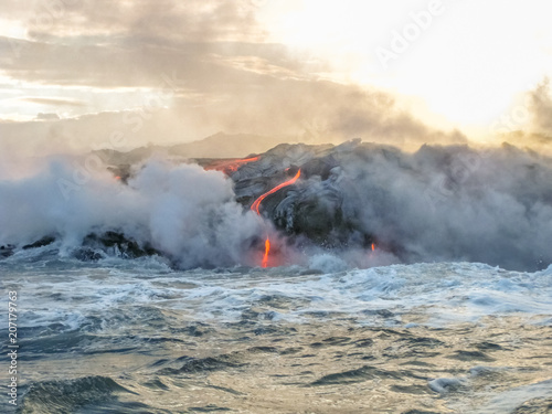 Kilauea Volcano in Hawaii Volcanoes National Park, also known Kilauea Smile because from 2016 seems to smile, erupting lava into Pacific Ocean, Big Island. Scenic sea view by boat. © bennymarty