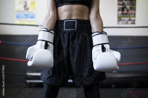 Strong female body with boxing gloves photo
