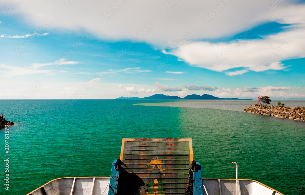 Fototapeta ferry boat sailing toward distant horizon beginning new journey with calm sea and bridge visible