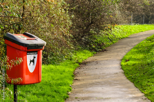 Photography Dog waste bin by a path in a park.