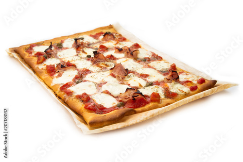 Homemade pizza with ham, mozzarella, tomato sauce, capers and oregano 