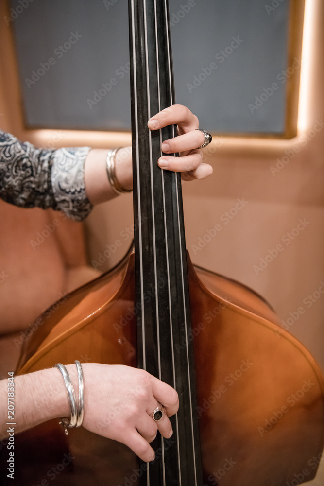 Crop man playing bass on rehearsal Crop man playing bass on rehearsal