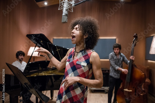 Woman singing on band rehearsal