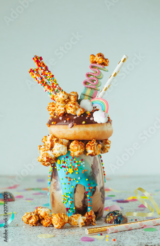 Billede på lærred Chocolate freak shake with donut on party table with copy space