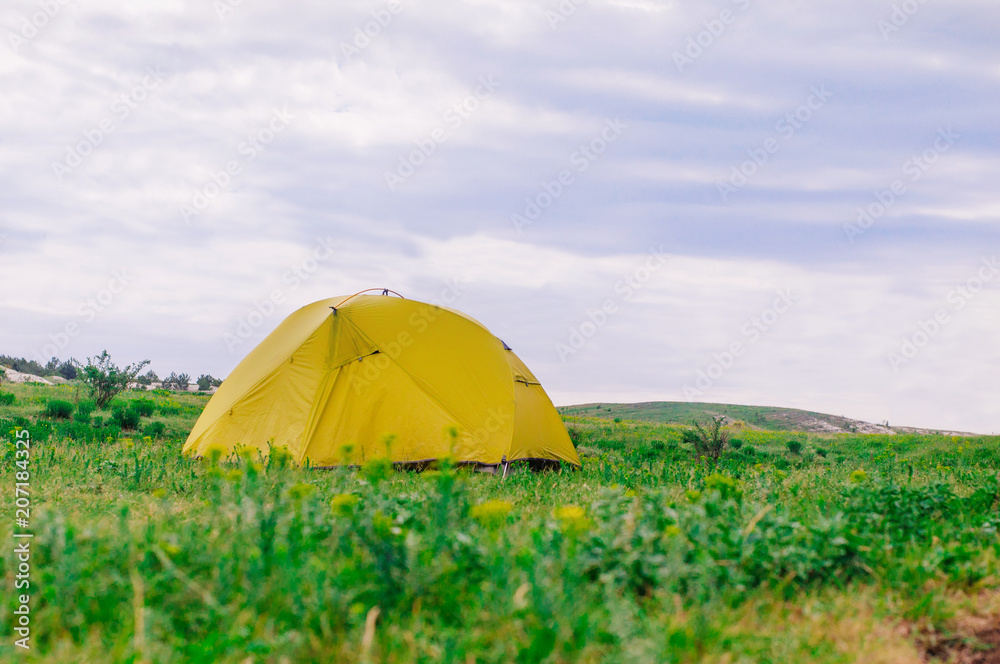 Tourist tent on the summer meadow