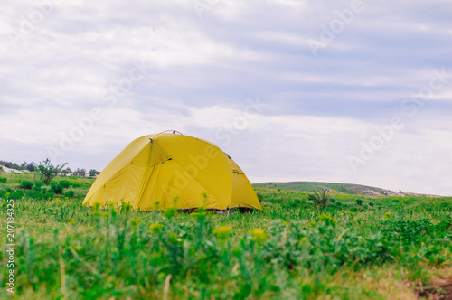 Tourist tent on the summer meadow