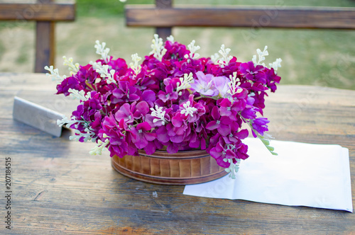 Fototapeta Naklejka Na Ścianę i Meble -  Flowers in basket on dinner table