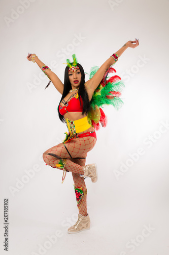 Fit young dark haired mixed race woman in Carnaval costume and athletic shoes posing on clean white background © Jeremy Francis