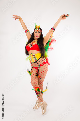Dark haired hispanic woman in Carnaval costume and athletic shoes posing on clean white background © Jeremy Francis