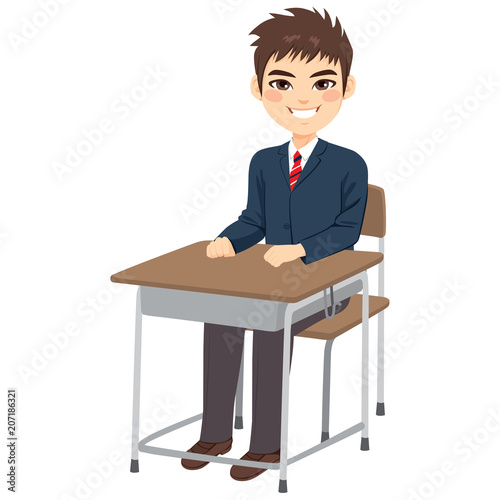 Young cute teenager student boy sitting on school desk