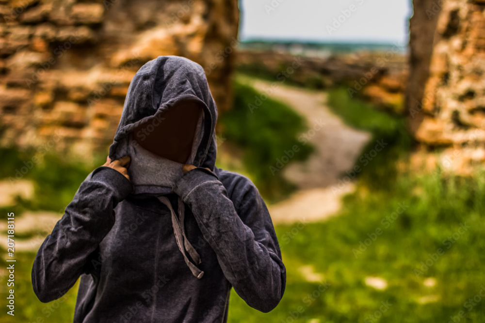 girl portrait without face hidden under hood in poor ruins environment girl portrait without face hidden under hood in poor ruins environment