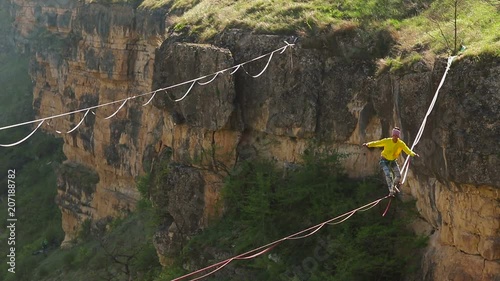 Funambulist at sunset in the mountains enjoying nature. slow motion