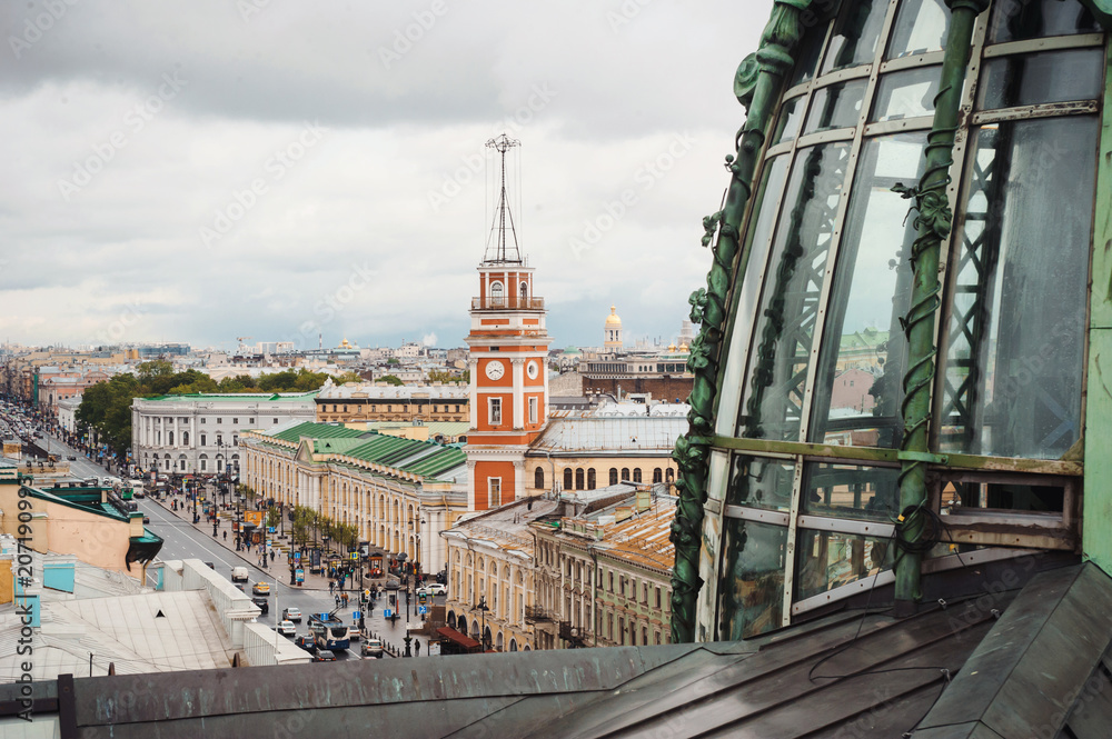 Obraz premium Panoramic view of the roofs with ventilation holes and chimneys, spiers, towers, domes of churches and cathedrals in the summer evening. Saint-Petersburg, Russia. Tourism world cup football 2018