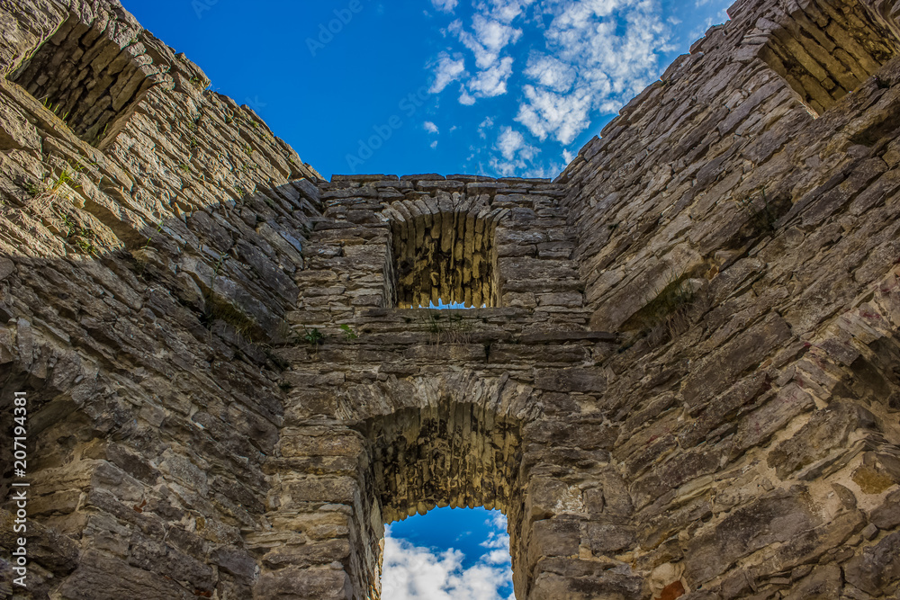 old ruins wall and blue sky background with empty space for copy or text
