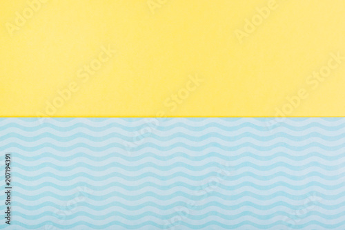 minimal summer yellow blue background symbolizing the sea with waves and sand.