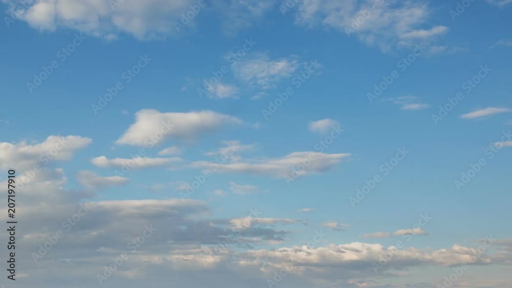 Russia, time lapse. Formation and rapid movement of white clouds of different shapes in the blue sky in late spring at sunset. Russia, time lapse. Formation and rapid movement of white clouds of different shapes in the blue sky in late spring at sunset.
