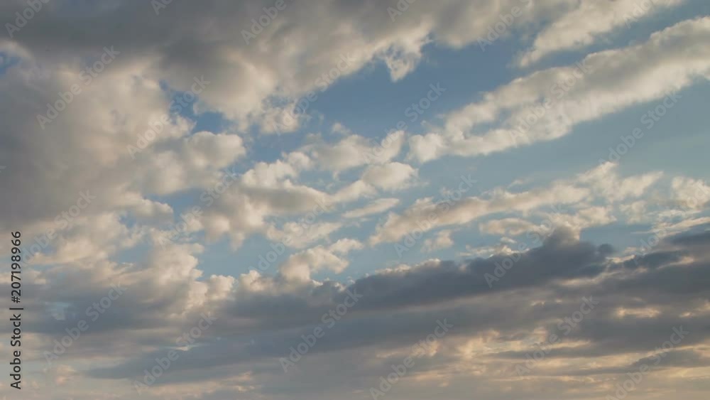 Russia, time lapse. Formation and rapid movement of white clouds of different shapes in the blue sky in late spring at sunset. Russia, time lapse. Formation and rapid movement of white clouds of different shapes in the blue sky in late spring at sunset.