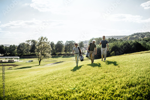 Group of friends walking on the golf course © VAKSMANV