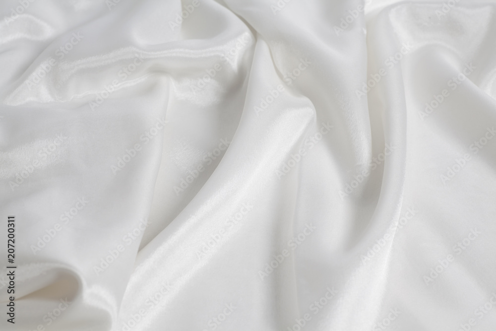 Closeup of rippled white silk fabric background