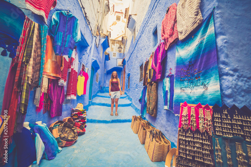 Happy young tourist backpackers on a street in Medina of the blue town of Chefchaouen, Morocco during Africa tour © photomaticstudio